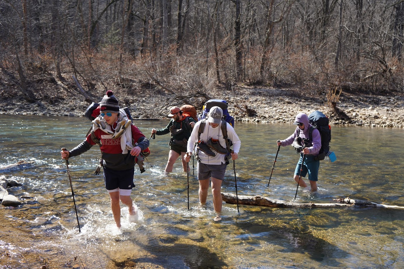 Students cross the Buffalo National River during a course backpacking trip.